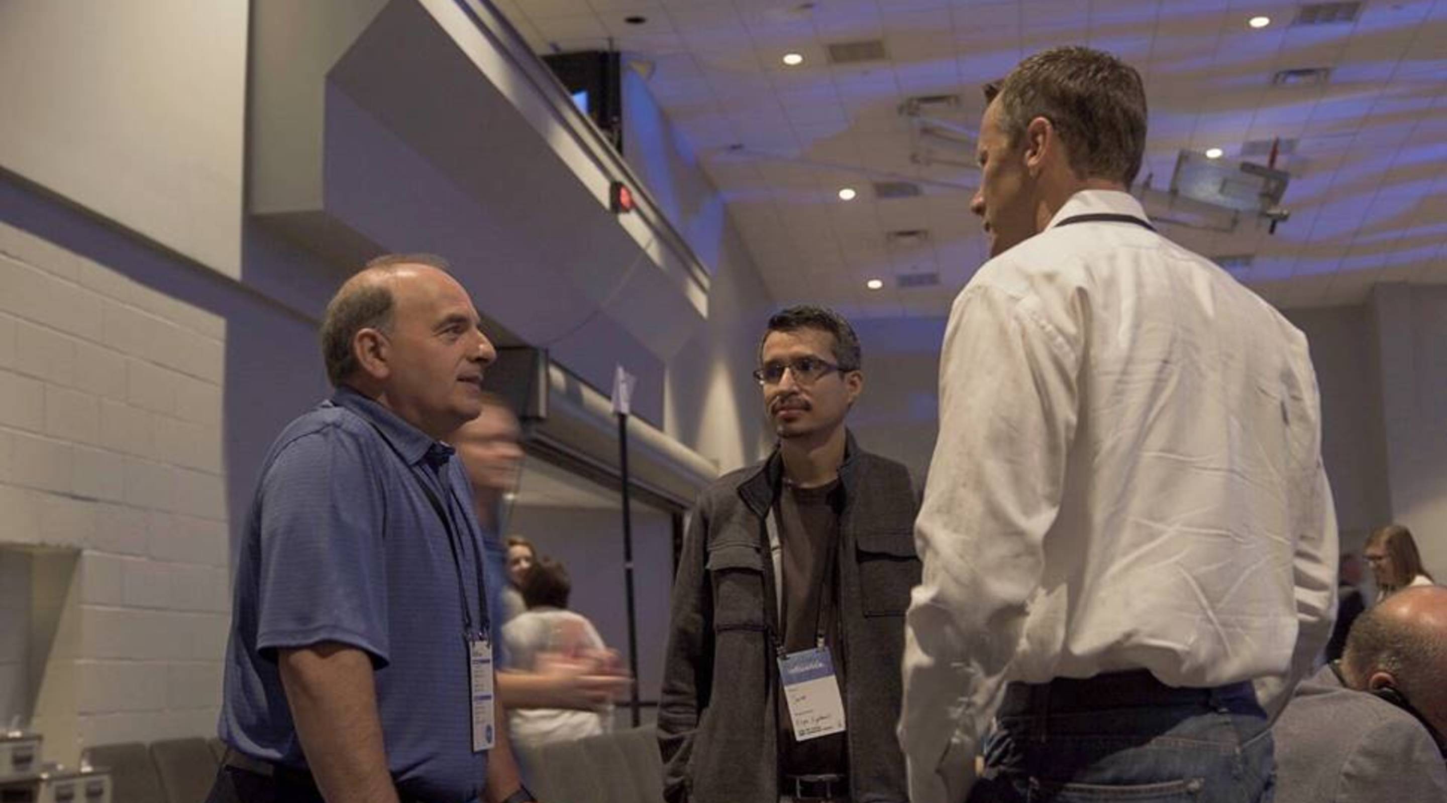 Team members networking on a conference floor