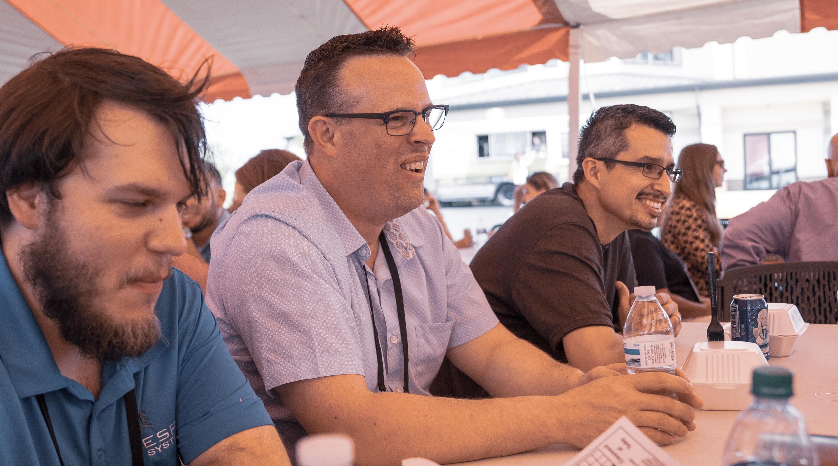 Team members sharing a laugh at an outdoor company outing